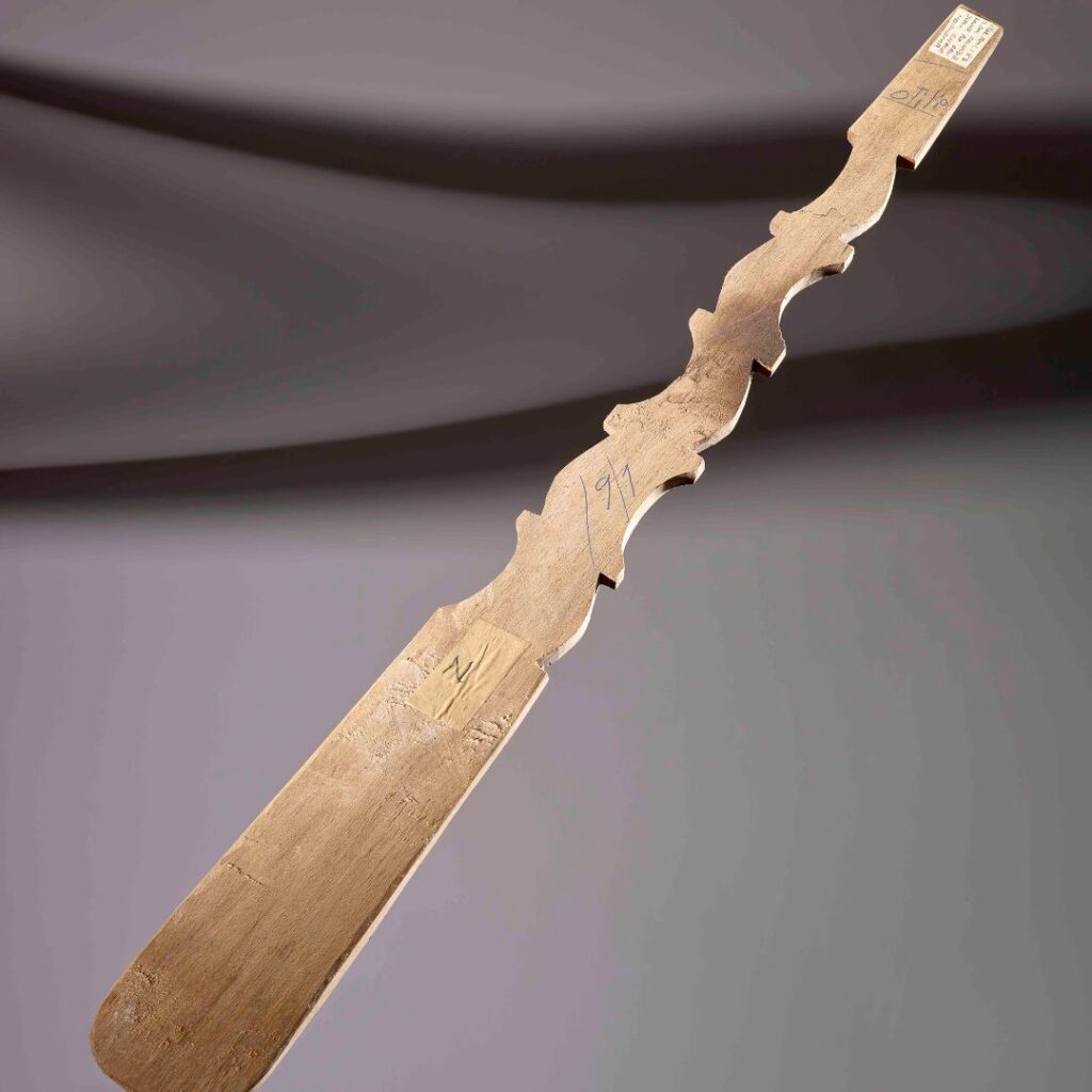 Brown wooden spoon with curved carvation and with an inscription with the name 'Otilio'