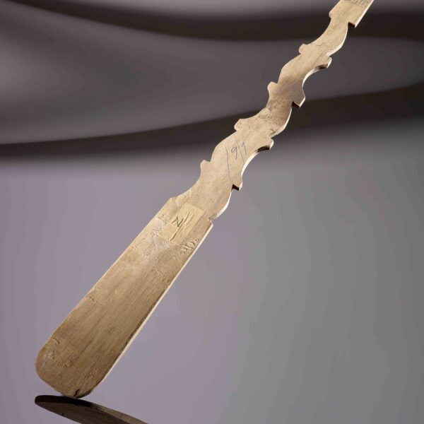 Photo of a carved wooden spoon with the inscription of the name 'Otilio' in blue pen