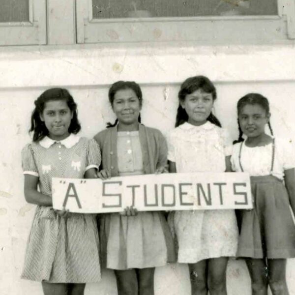 Group of four girls holding a sign that says 'A Students'