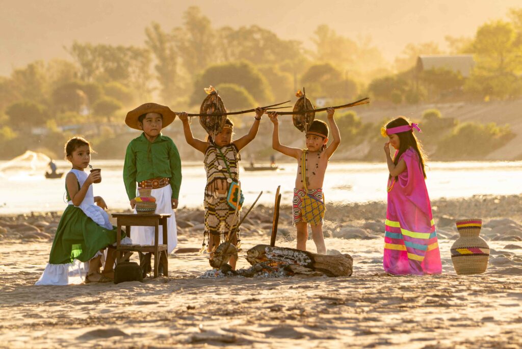 Photo of five kids dressed up with different clothing and holding tools or objects to showing a diversity of cultures